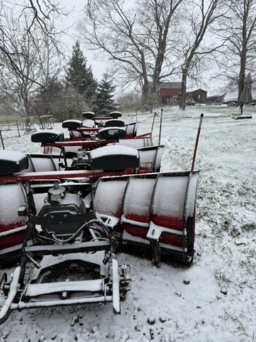 Snow removal plows lined up in the snow